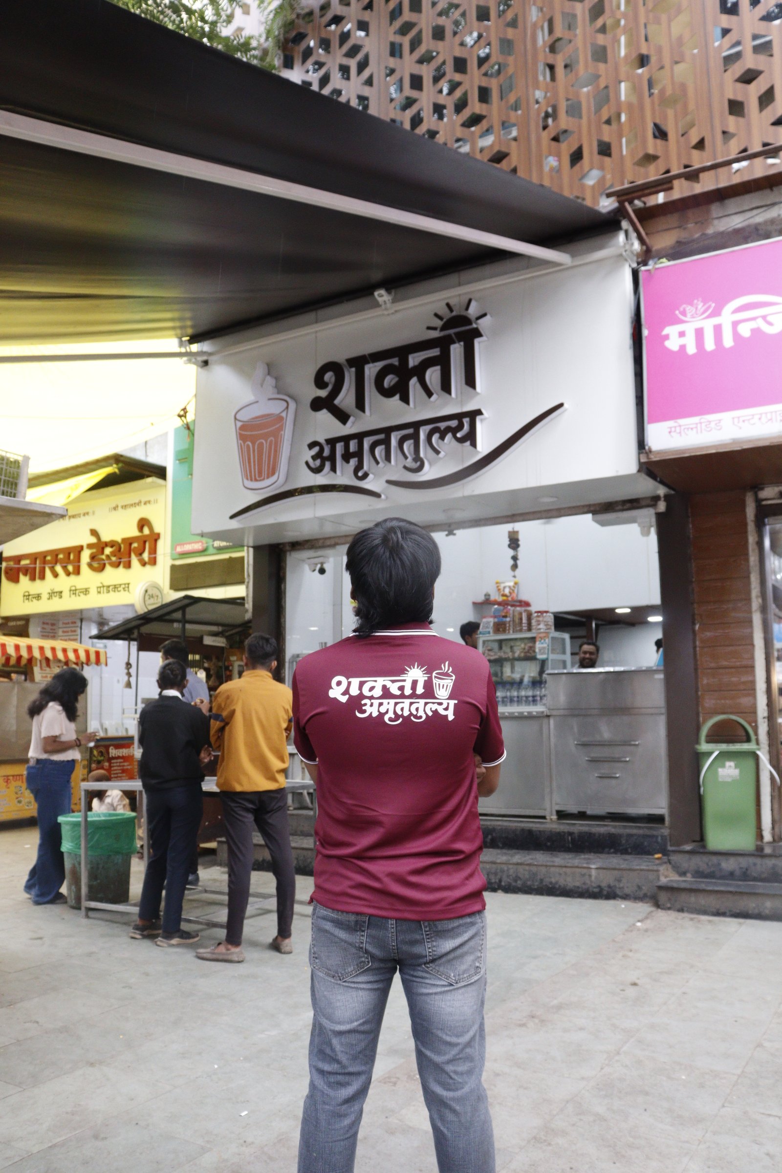 Shakti Amrutatulya team member standing outside the outlet