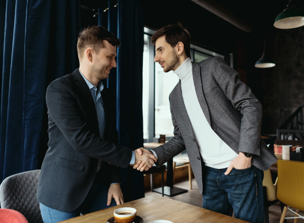 Business partners shaking hands for a brand partnership